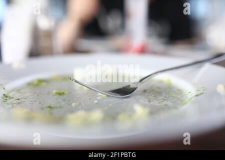 The cutlery lies on an empty white plate Stock Photo
