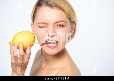Recharge your body vitamins. Girl drink fresh juice whole lemon fruit. Energy source and vitality. Battery concept. Nutritious drink fill with energy. Lemon with hobnail natural battery. Stock Photo