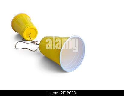 Comunication Yellow Plastic cup with string isolated on white background Stock Photo