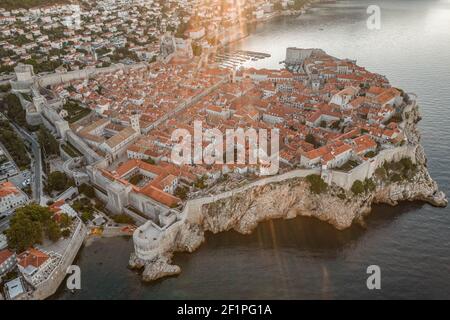 Aerial drone shot of Dubronik city wall by Adriatic sea in Croatia summer sunrise Stock Photo