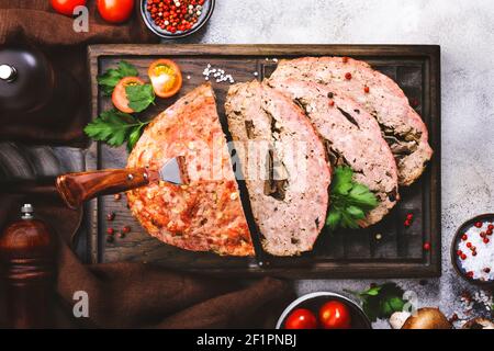 Meatloaf with mashrooms, american food with baked pork beef minced meat on gray table. Top view, copy space Stock Photo