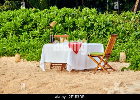 Table set up for romantic dinner on beach at Seychelles Stock Photo