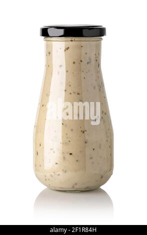 Closed glass jar of white garlic and herb sauce Stock Photo