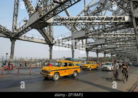 Kolkata, India - January 2021: Taxis circulating on the Howrah Bridge on January 29, 2021 in Kolkata, West Bengal, India. Stock Photo