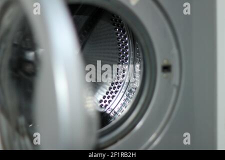 An empty washing machine with the door open Stock Photo