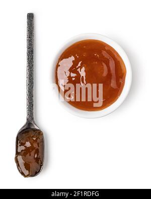 Small glass bowl and spoon of apricot jam Stock Photo