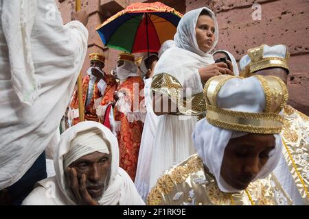 Pilgrims watch the crowds below at St. Emmanuel Church during Gena, the Ethiopian Orthodox Christmas celebration in Lalibela, Ethiopia. Stock Photo