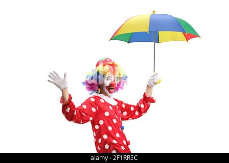 Clown waving and holding an umbrella isolated on white background Stock Photo