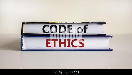 Code of ethics symbol. Concept words 'Code of ethics' on books on a beautiful white table, white background. Business and code of ethics concept. Copy Stock Photo