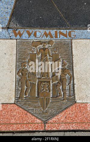 Bas relief plaque for Wyoming is inlaid into Hoover Dams plaza's surface, one of the seven states that fall within the Colorado River's basin. Hoover Stock Photo