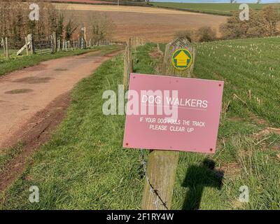 Dog Walkers Sign to Please Clear Up if Your Dog Fouls the Track on a Devon County Council Public Footpath on a Farm in the Rural Devon Countryside Stock Photo