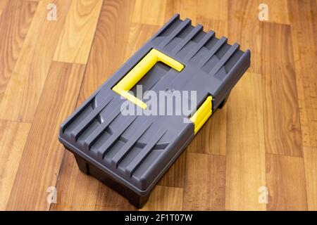 Gray plastic box on a wooden floor close up Stock Photo