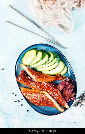 Fried unagi eel with sauce sesame and rice close-up Stock Photo