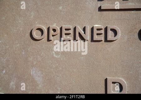 "Opened" word on a metal commemoration plaque. Stock Photo