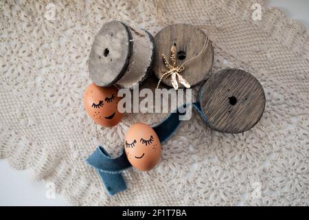 A top view of beautifully decorated Easter eggs on a white fabric background Stock Photo