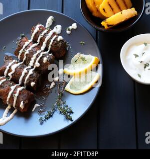 Traditional turkish dolma, sarma or dolmades. Dolmadakia or stuffed grapes leaves on dark background. Traditional mediterranean dish. Stock Photo
