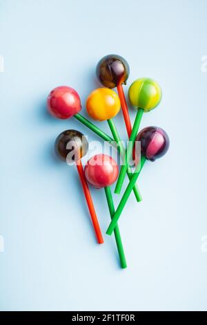 Sweet fruity lollipops on colorful background. Top view. Stock Photo