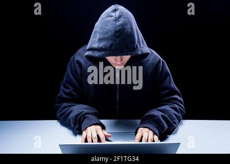 Hacker in data security concept using laptop in Cyber attack Stock Photo