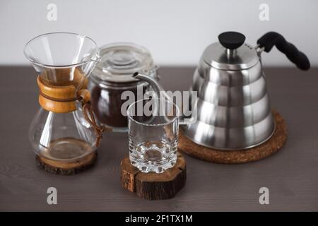 A drip coffee set with a Steel kettle, glass, and hand drip coffee