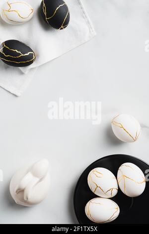 Happy Easter vertical banner design. Luxury Easter eggs, bunny on marble desk. Flat lay, top view, copy space. Stock Photo