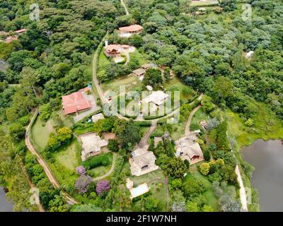 Aerial view of valley with lake, forest and villa in tropical country