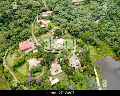 Aerial view of valley with lake, forest and villa in tropical country