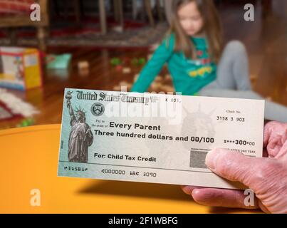 US Treasury illustrative check for child tax credit for a small girl to illustrate American Rescue Plan Act of 2021 payments Stock Photo