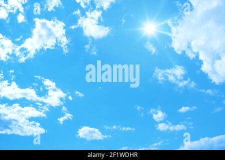 Typical blue sky with sun and clouds background Stock Photo