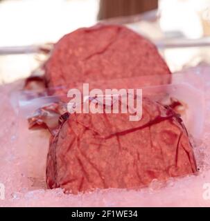Individual sealed hamburger steak patties packaged for sale at a farmer’s market in Southern California. Stock Photo