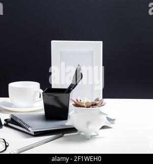office supplies on Minimalistic workplace in black and white color with office supplies, notebooks, office plant flower on table for work or study. Ho Stock Photo