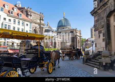 Coachmen with horse and carriage wait for tourists at the Frauenkirche Church in Dresden Stock Photo