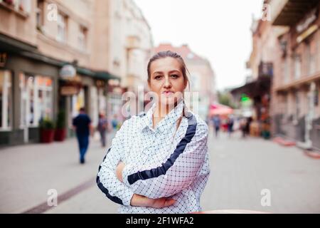 Happy young woman looking around in the city Stock Photo