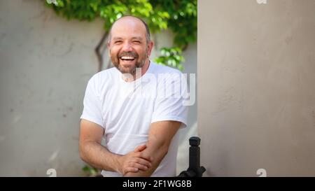 Bearded bald man laughing Stock Photo