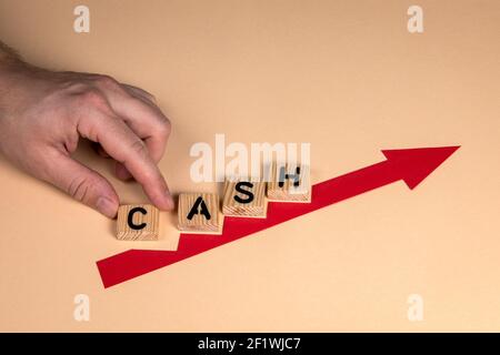 CASH. Savings, investment and business concept. Red arrow indicates the development and growth. Stock Photo