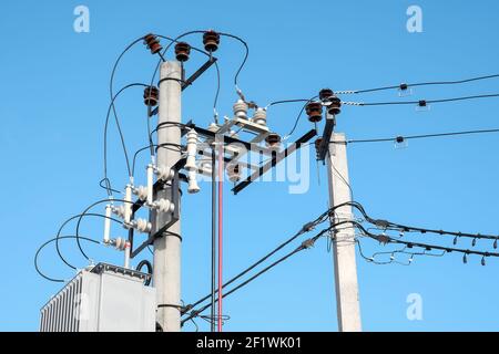 Transformer mounted on a pole on blue sky background Stock Photo