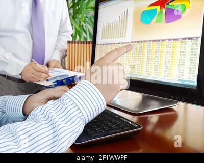 Analyzing data on computer Stock Photo