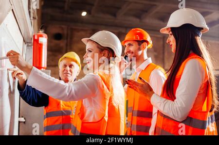 The workers draw up a plan of work at the plant Stock Photo