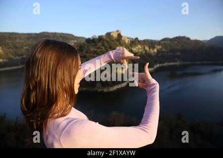 Woman framing with fingers in a river on vacation Stock Photo