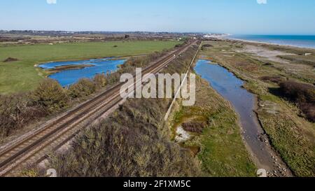 Aerial view of railway line towards Cooden and Bexhill at Normans Bay, East Sussex, UK Stock Photo