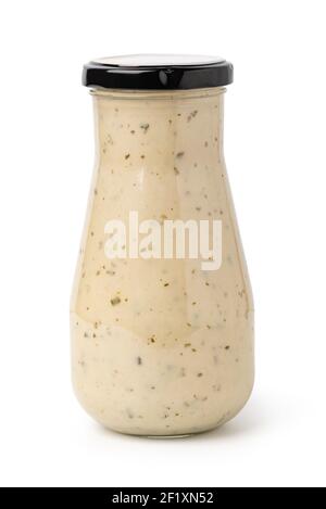 Closed glass jar of white garlic and herb sauce Stock Photo