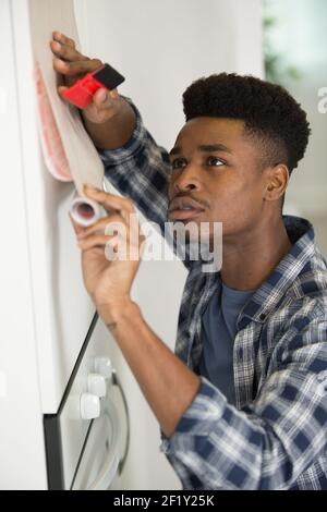 man revamping his kitchen cupboard Stock Photo