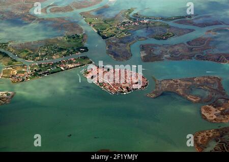 View from the air of the picturesque Island of Burano in the Venetian Lagoon. The island is famous for its multi-coloured houses. The island to the im Stock Photo