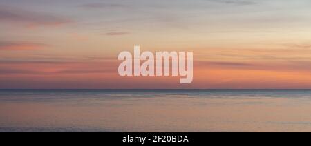 Beautiful sunset over the ocean with colorful sky Stock Photo