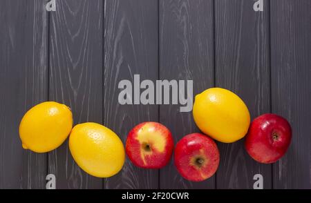 apples and lemons on a wooden gray board Stock Photo