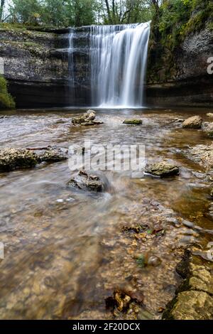 A beautiful autumn forest landscape with idyllic waterfall and pool Stock Photo