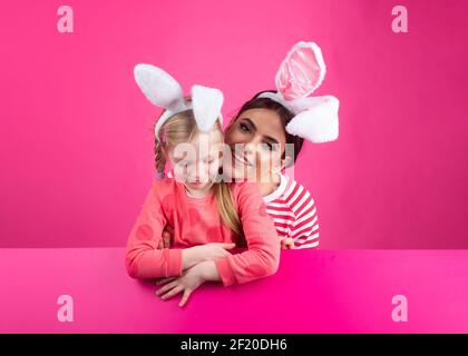 Family easter. Sister girls with bunny ears. Egg hunt. Happy childhood. Isolated. Stock Photo
