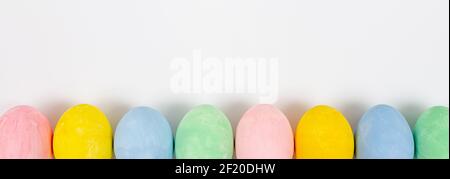 Easter eggs on white background. Easter frame of colorful eggs. Top view, copy space Stock Photo