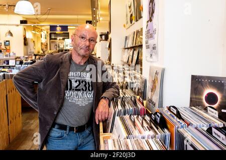 Tilburg, Netherlands. A Mature adult balding man visiting a vintage Vinyl record store to find his kind of music. Now sales of CD's are in decline, Vinyl records are booming! Stock Photo