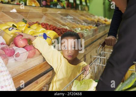 A cute little girl in the supermarket Stock Photo