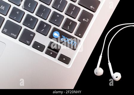 The logo of tele conferencing app Zoom on a keyboard. Illustration. Stock Photo